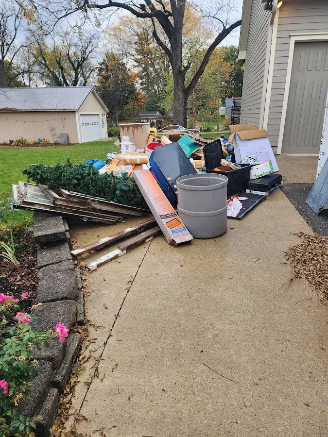 Dumpster being loaded with debris for 12 Yard Dumpster Rental in Upper Allen